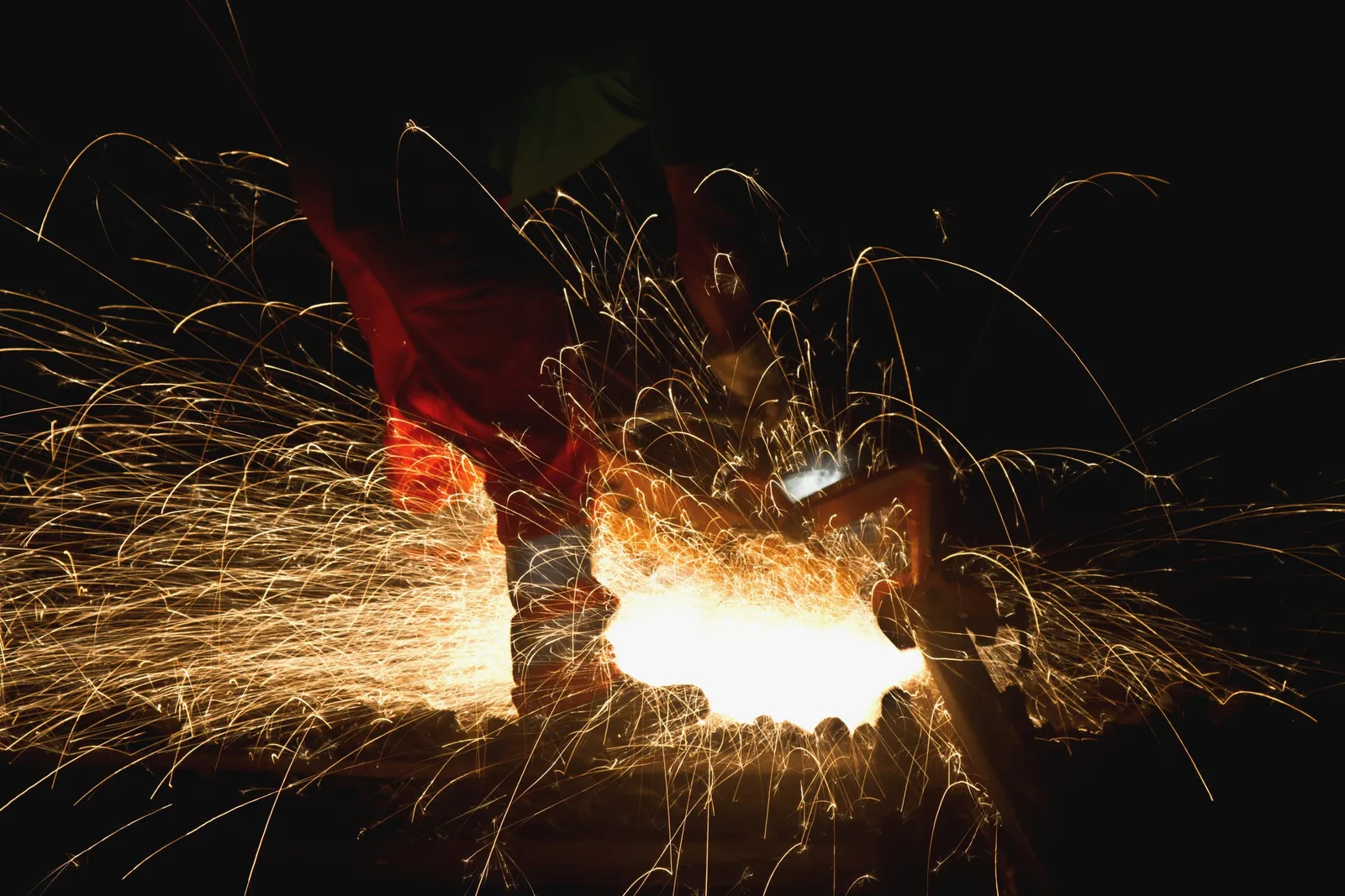 Blacksmith at work, sparks flying from forge work