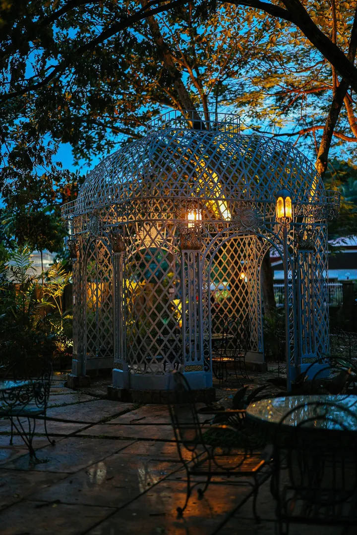 Garden gazebo lit up at dusk