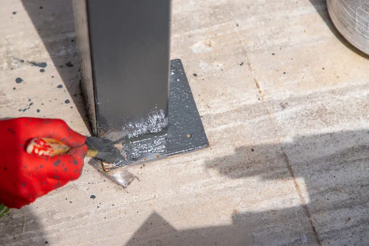 Ground anchor plate of a metal post, rust-proof finish
