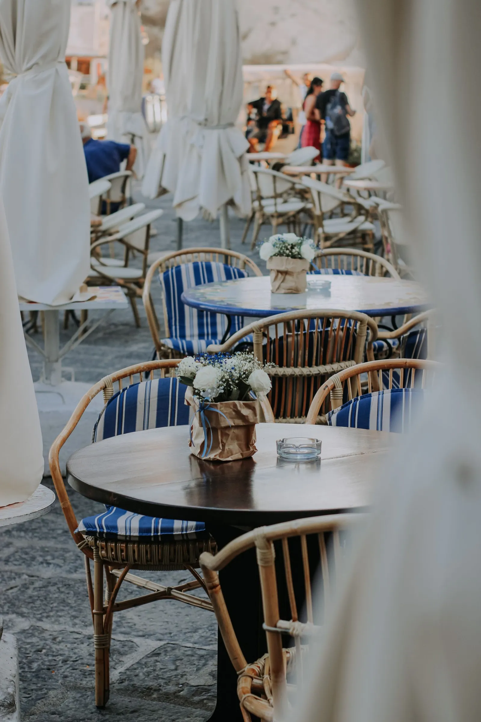 Rattan chairs and round tables on a terrace